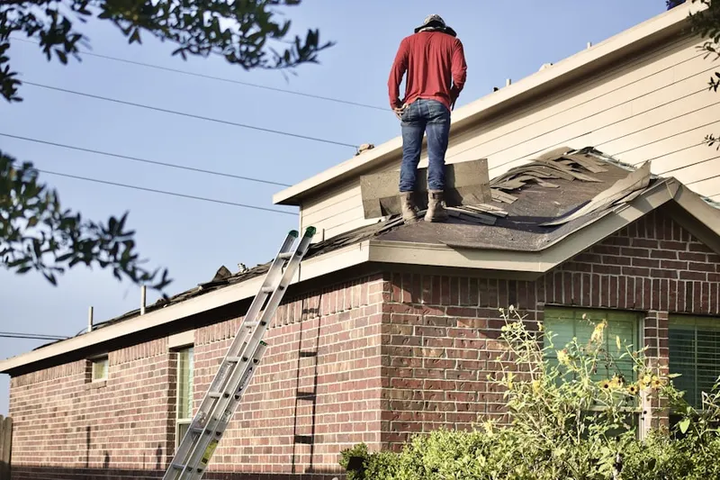 Professional roofer working on a residential roof in Hollywood Hills East